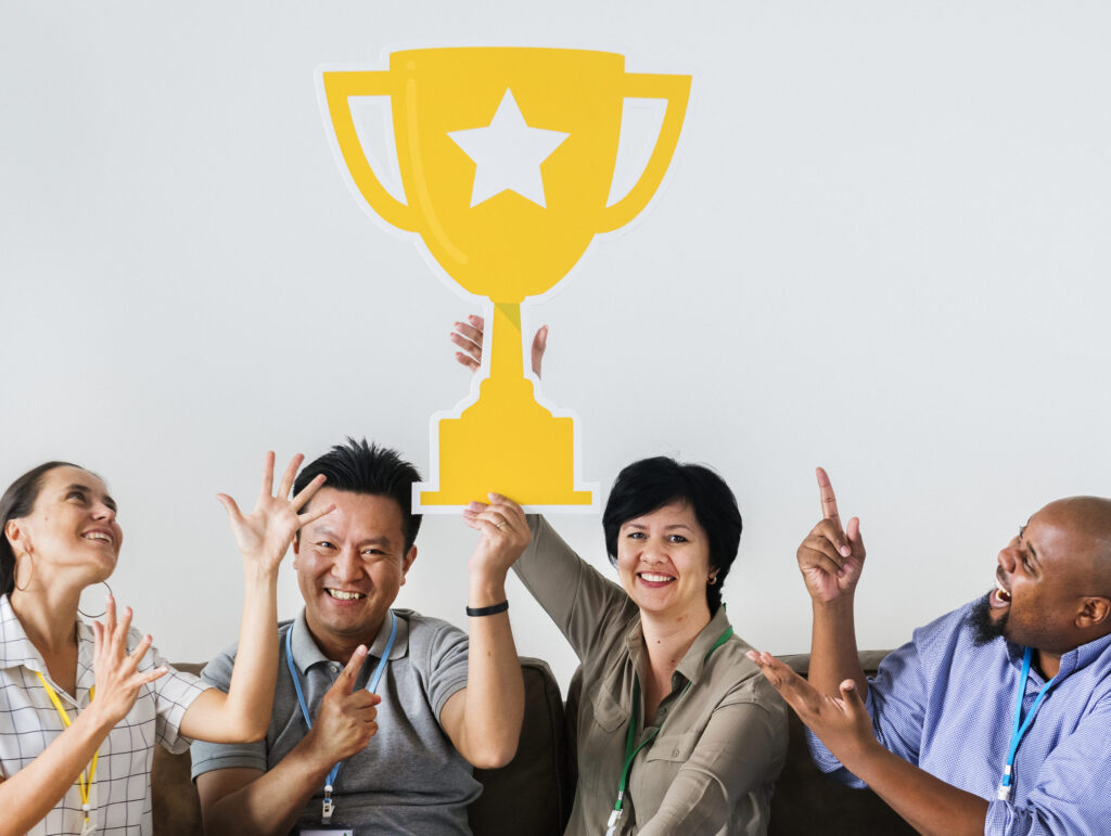 workers celebrating their success with trophy (1)